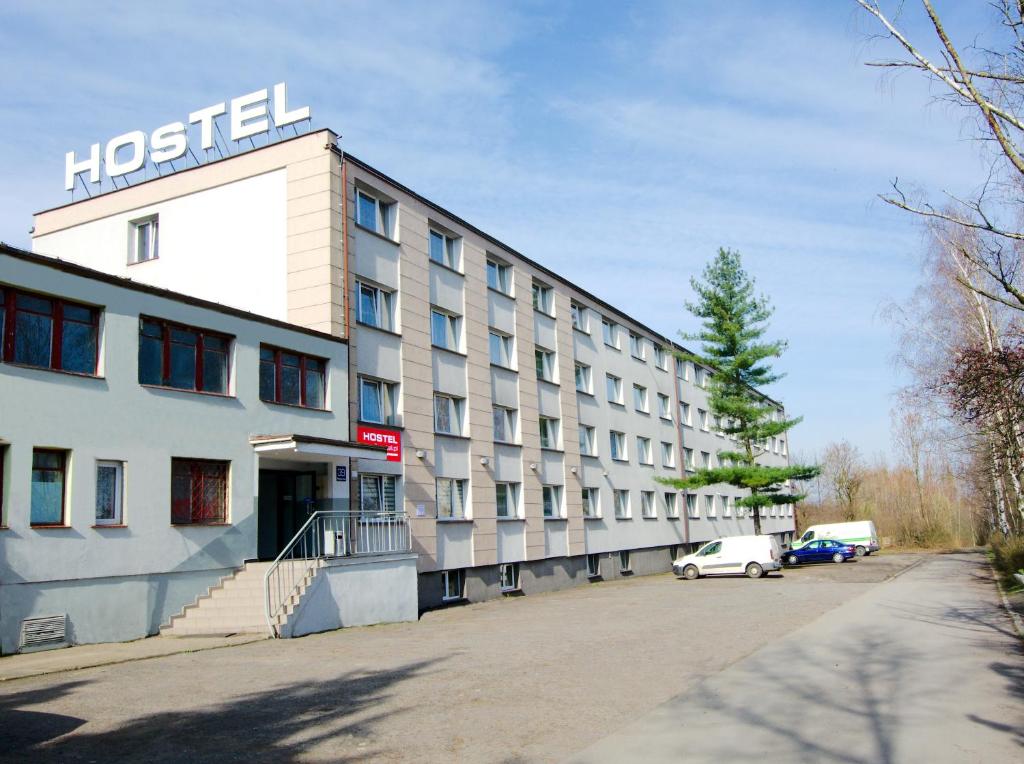 魯達希隆斯卡的住宿－Twój Hostel Ruda Śląska，一座酒店大楼,前面有停车位