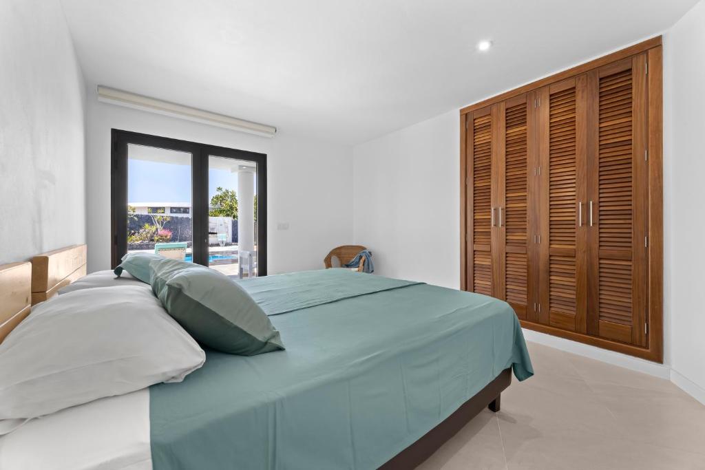 A bed or beds in a room at Casa Marina with pool, garden and terrace