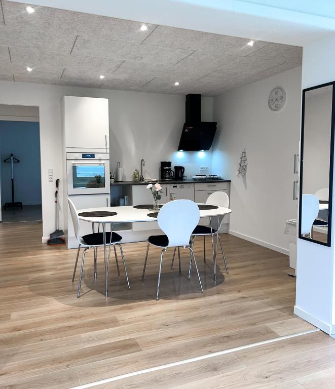 a kitchen with a table and chairs in a room at The Heart of Billund apartment in Billund