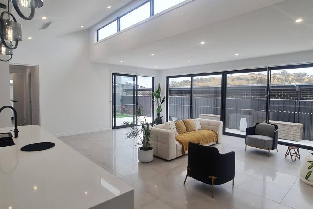 a living room with a couch and a table at Luxury holiday home in Weetangerra