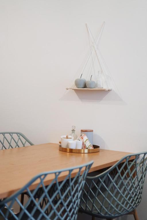 a dining room table with two chairs and a shelf at Apartmány KiRi in Kyjov