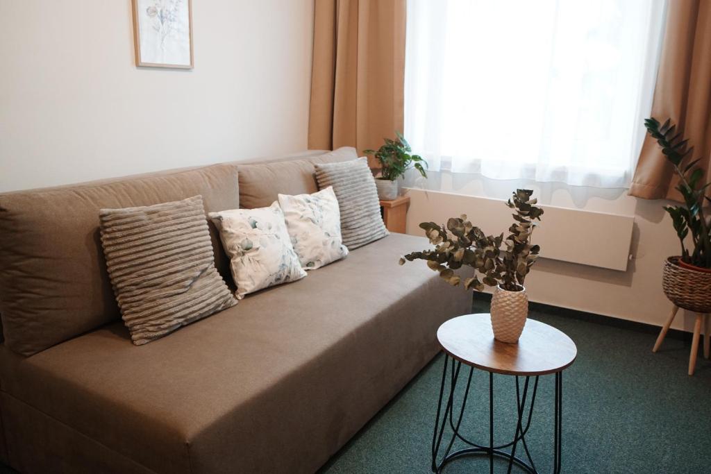 a living room with a couch and a table at Apartmány KiRi in Kyjov