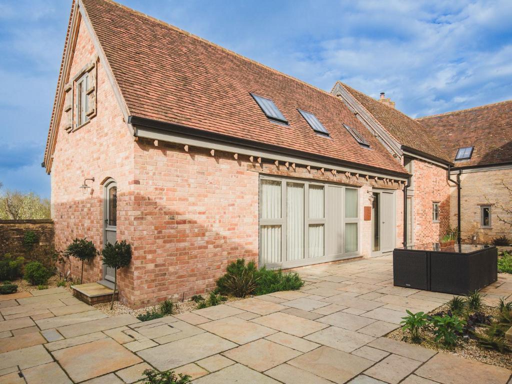 a brick building with two garage doors on it at The Coach House at Stoneythorpe in Southam