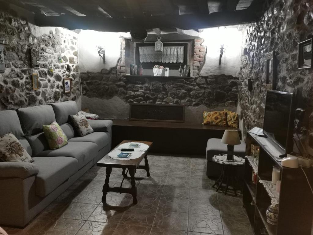 a living room with a couch and a table at MRZ rentals LA CASINA in Cudillero