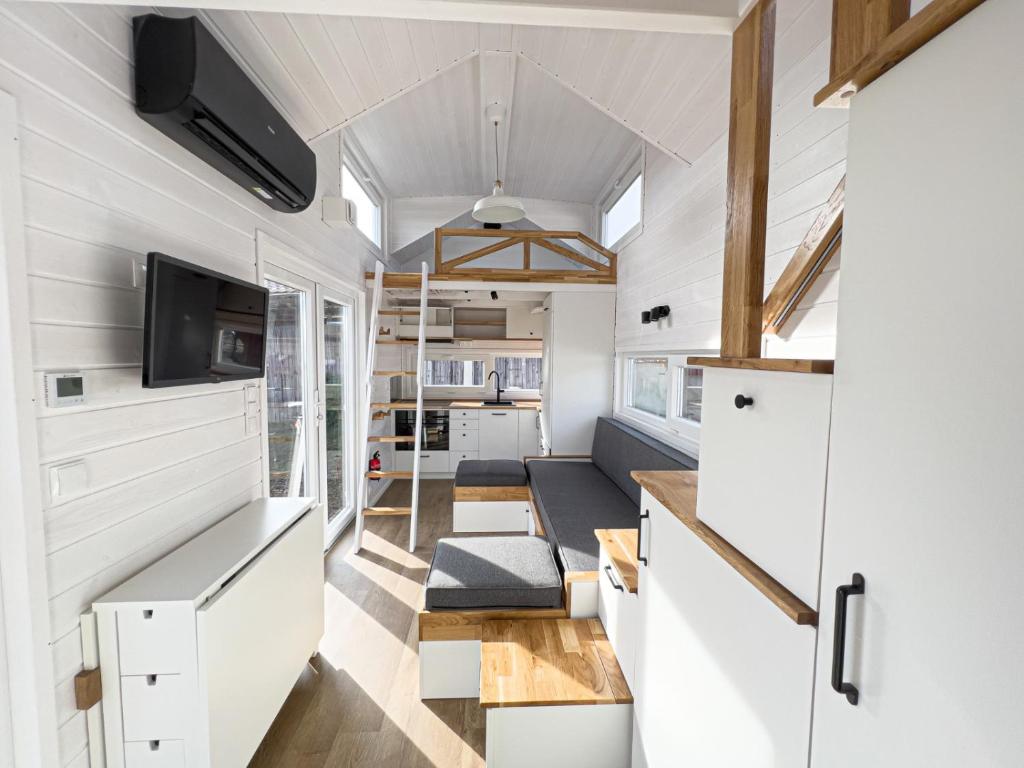 a kitchen and living room in a tiny house at Red Tiny House in Sopot