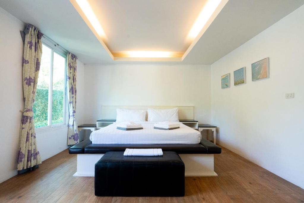 a bedroom with a bed and a large window at 752 Residence Hua Hin in Hua Hin
