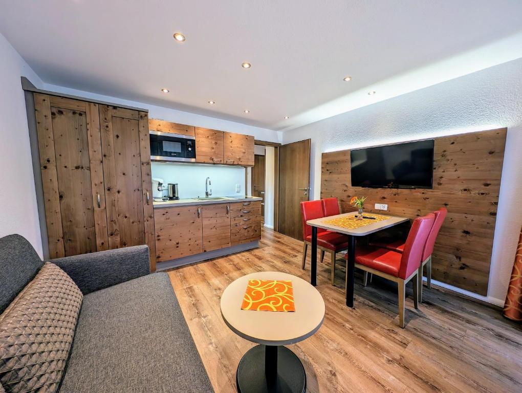 a living room with a couch and a table at Hotel Zum Löwen - Unteres Wirtshaus in Titisee-Neustadt