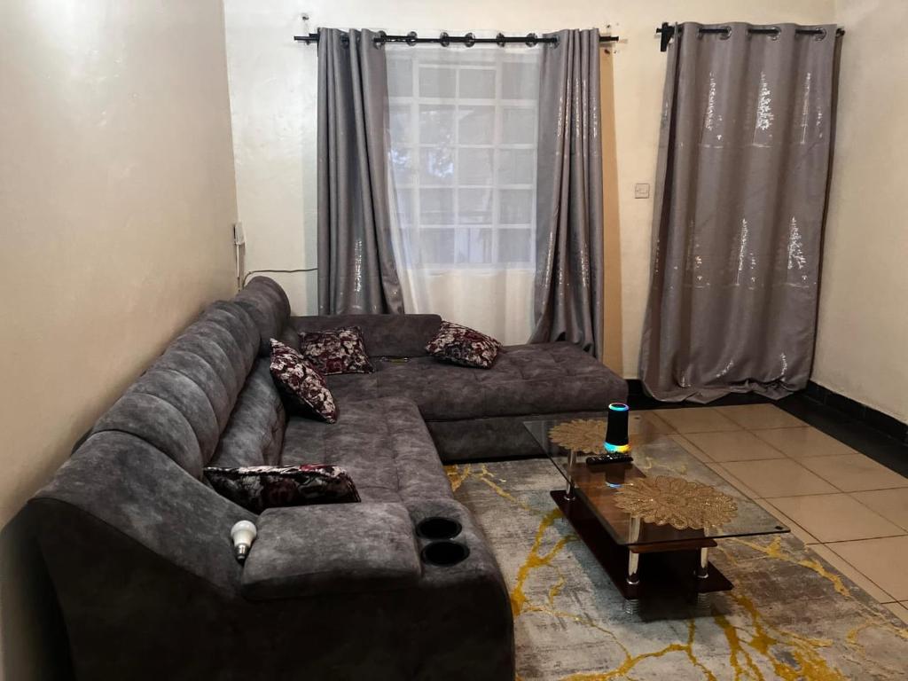 a living room with a couch and a coffee table at Klimax Homes in Kiambu