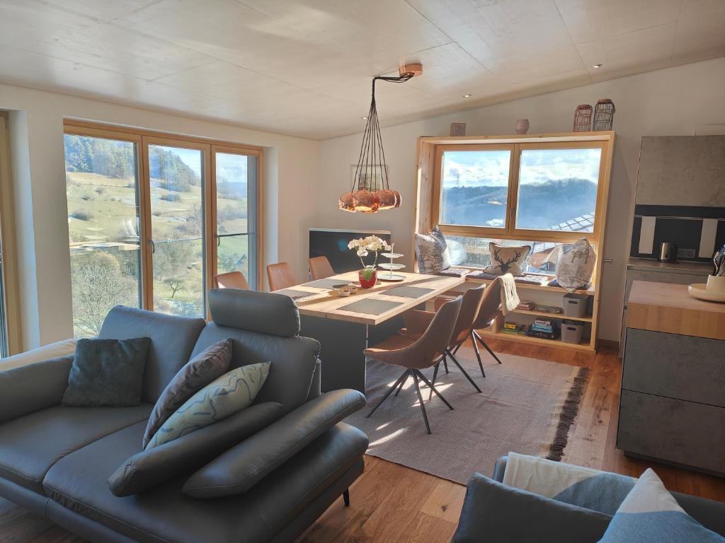 a living room with a couch and a dining table at Thomas's Loft in Stühlingen