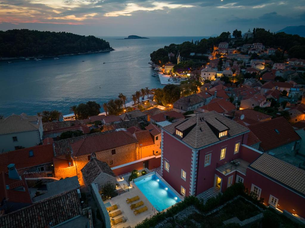 an aerial view of a town at night with theovi river at Cavtat Old School in Cavtat