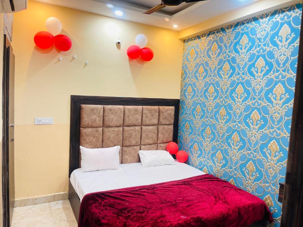 a bedroom with a bed with red balloons on the wall at Star hotel in Jabalpur