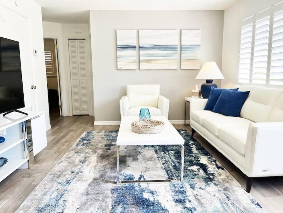 a living room with a white couch and a coffee table at Modern Apartment - 3 of 4 in Punta Gorda