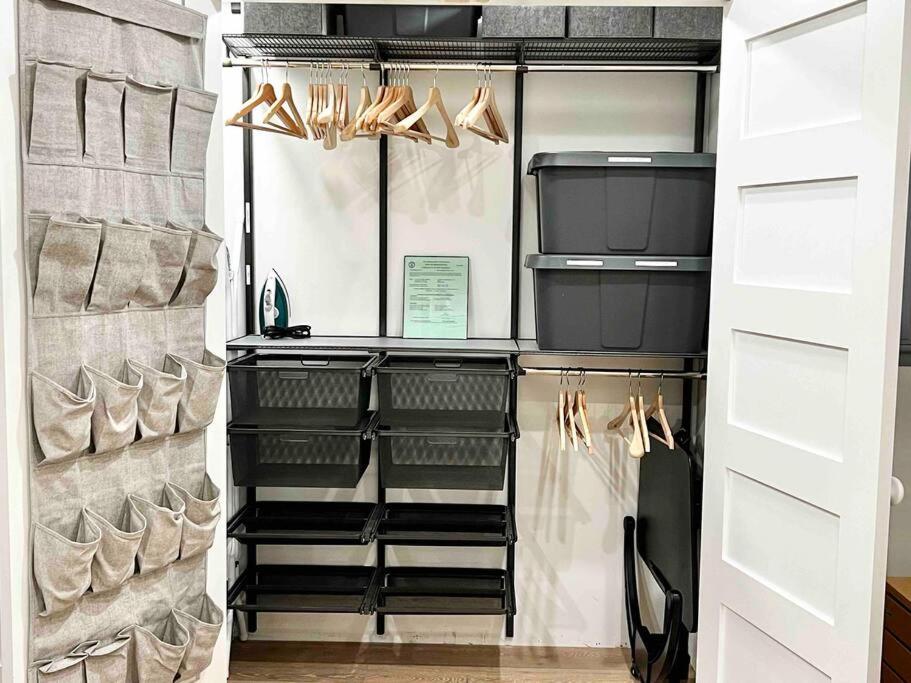 a walk in closet with black shelves and shoes at Luxury Water-View West End Condo in Provincetown