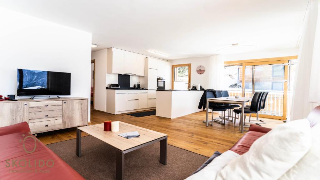 a living room with a couch and a table at Haus Golmenegg, Riederalp in Riederalp