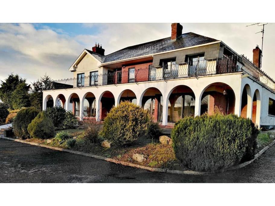 a large house with a balcony on top of it at Annalee House, Knappagh Valley - 1 hour to Airport in Shercock