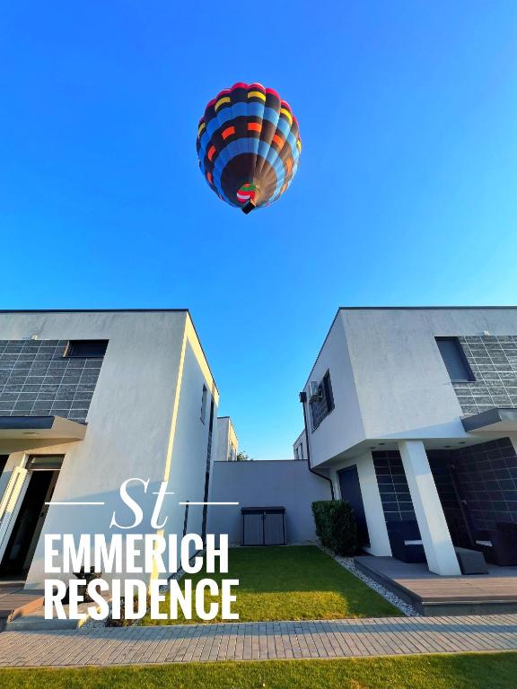 a hot air balloon is flying over a building at St Emmerich Residence in Győr