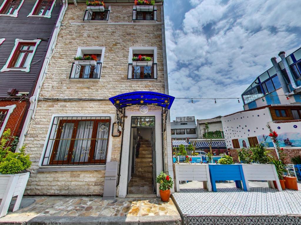 a building with a blue table and chairs in front of it at Denis suit apart in Istanbul