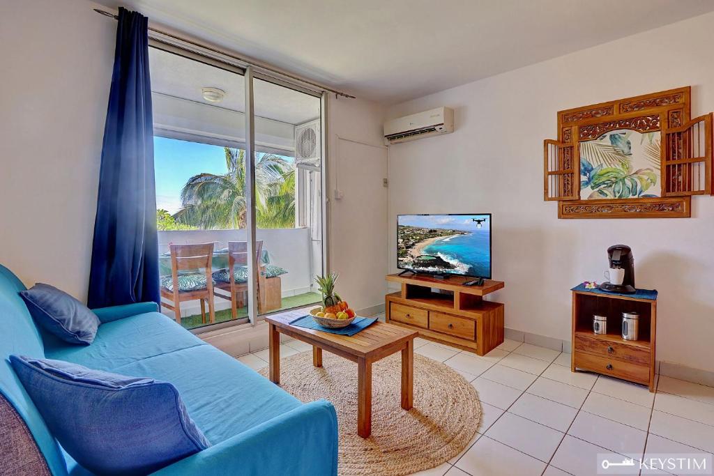 TV a/nebo společenská místnost v ubytování Pitaya - Studio proche plage