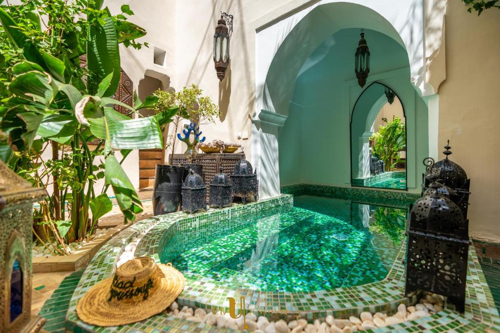 a swimming pool in a house with a tile floor at Riad El Youssoufi in Marrakesh