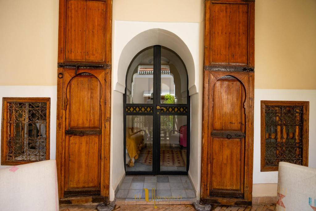 an entrance to a building with wooden doors at Riad El Youssoufi in Marrakesh