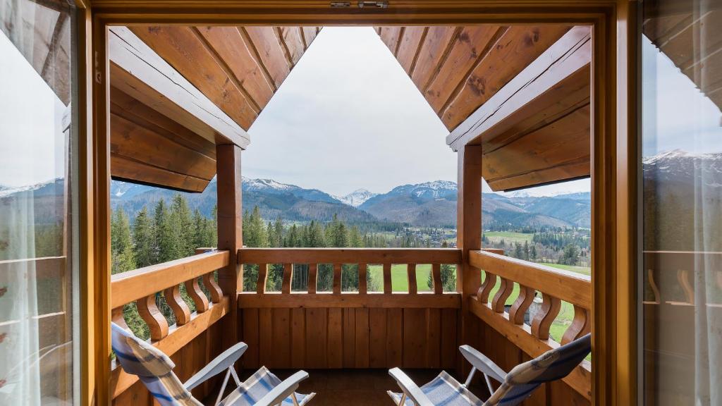 a balcony with chairs and a view of mountains at Kierpcówka, Sun & Snow in Kościelisko