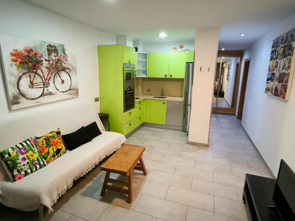 a living room with green cabinets and a couch at Olof Apartment in Las Palmas de Gran Canaria