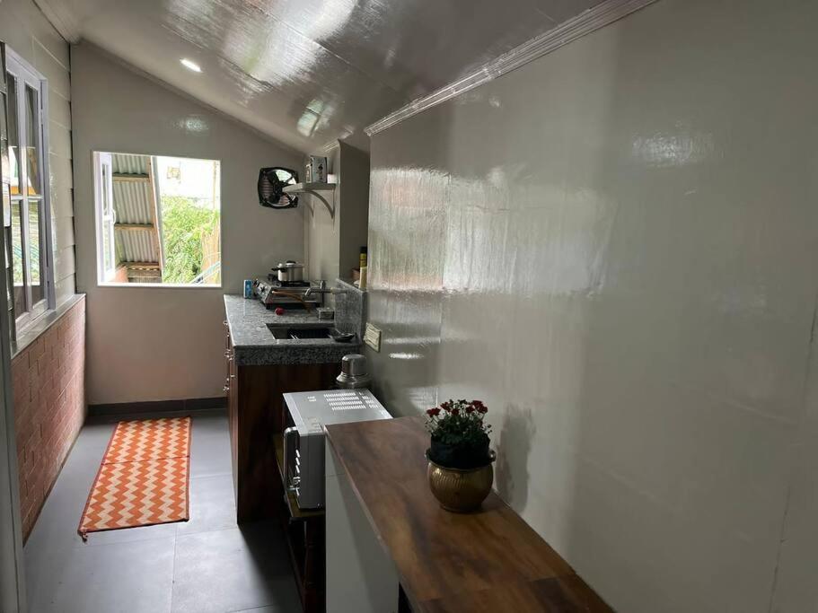 a kitchen with a table in the middle of a room at Darjeeling CoLiving Home in Darjeeling
