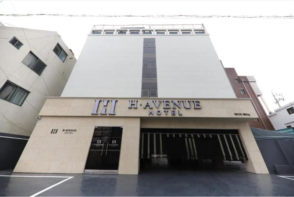 a building with a sign that reads hr insurance agent at H Avenue Hotel Chungjangro in Gwangju