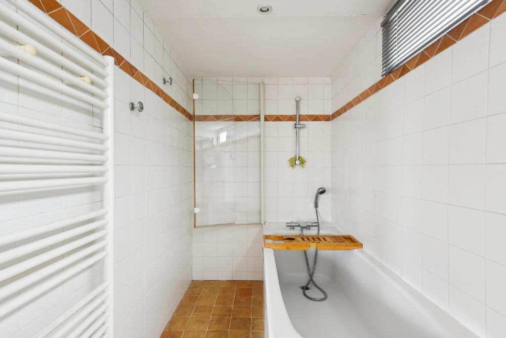 a bathroom with a sink and a shower at Appartement atypique à Montsouris by Weekome in Paris