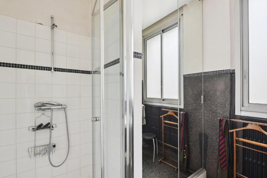 a bathroom with a shower and a window at Appartement atypique à Montsouris by Weekome in Paris
