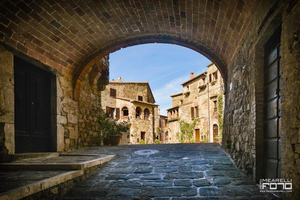 une arche dans une ruelle d'un vieux bâtiment dans l'établissement Il Campanile, à Montemerano
