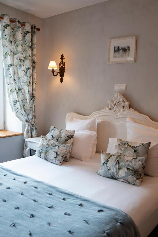 Postel nebo postele na pokoji v ubytování Hôtel Le Clos