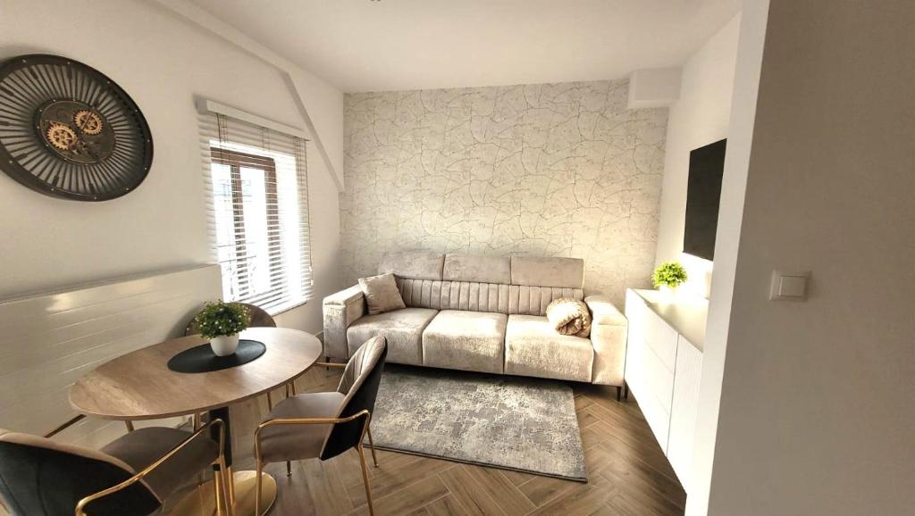 a living room with a couch and a table at APARTAMENT JARACZA 28/17 in Słupsk