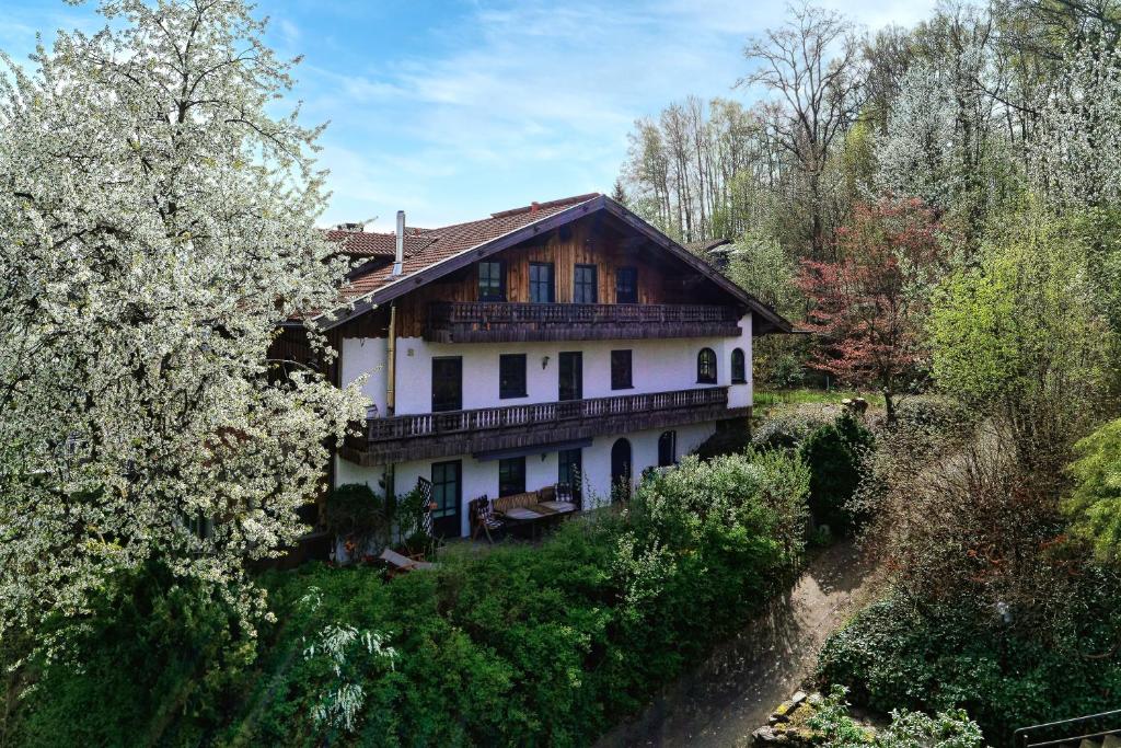 a large house on a hill with trees at Landhaus Melch in Zwiesel