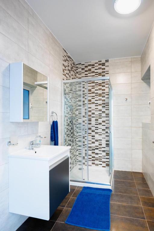 a bathroom with a sink and a shower at Msida Central Suites in Msida
