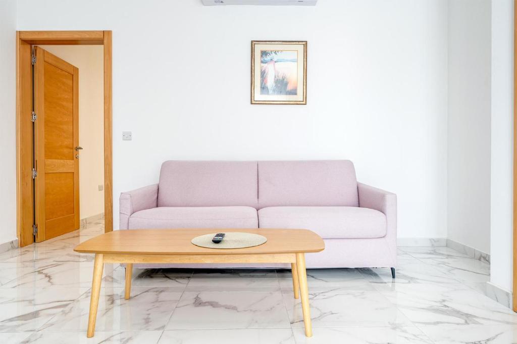 a living room with a couch and a coffee table at Msida Central Suites in Msida