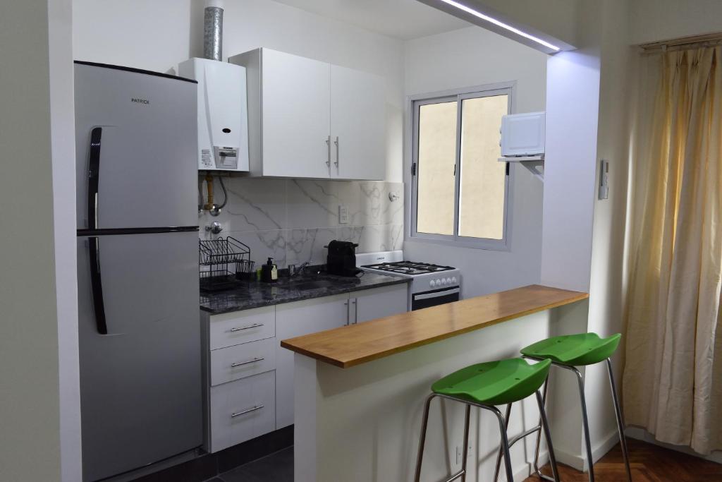 a kitchen with white cabinets and a white refrigerator at Belgrano Cozy Suite in Buenos Aires