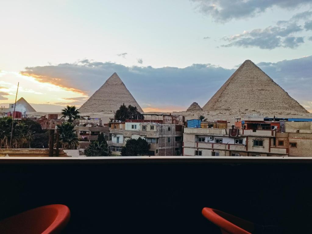 a view of the pyramids of giza from a hotel room at Fantastic three pyramids view in Cairo
