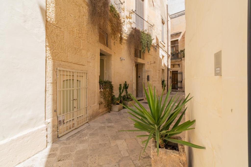 an alley in an old building with a plant at Corte dei Condò Luxury Rooms in Lecce