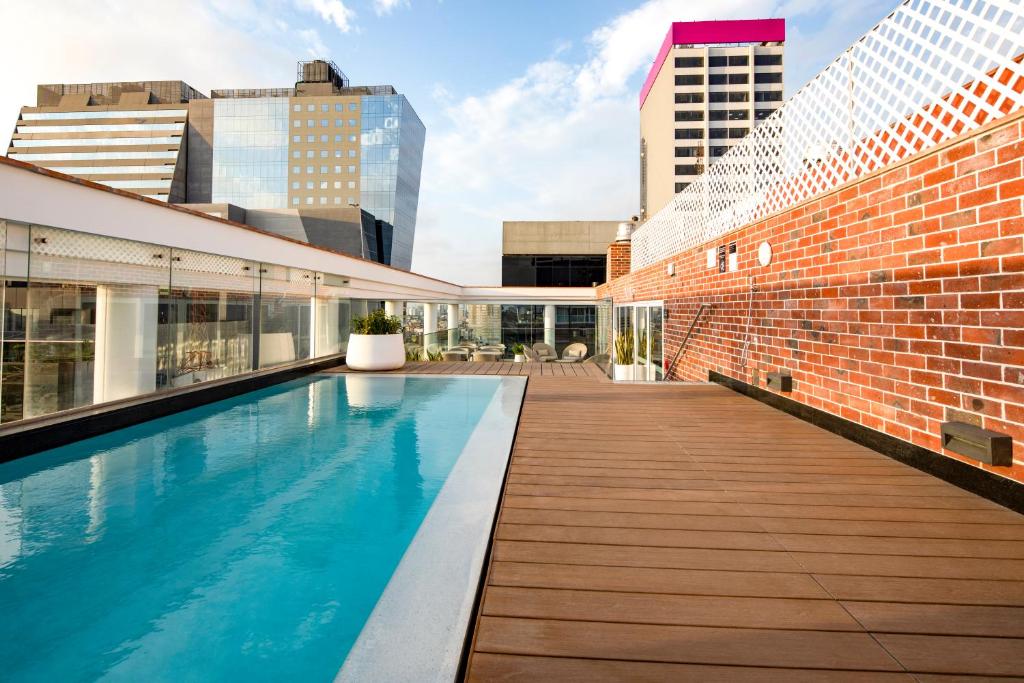 a swimming pool on the roof of a building at Casa Andina Premium San Isidro in Lima