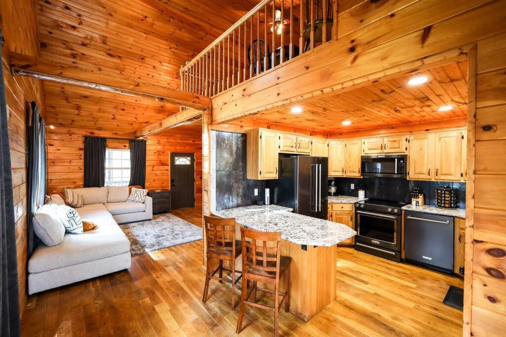 a kitchen and living room in a log cabin at The Lodge at Mt. Hersey in Hasty