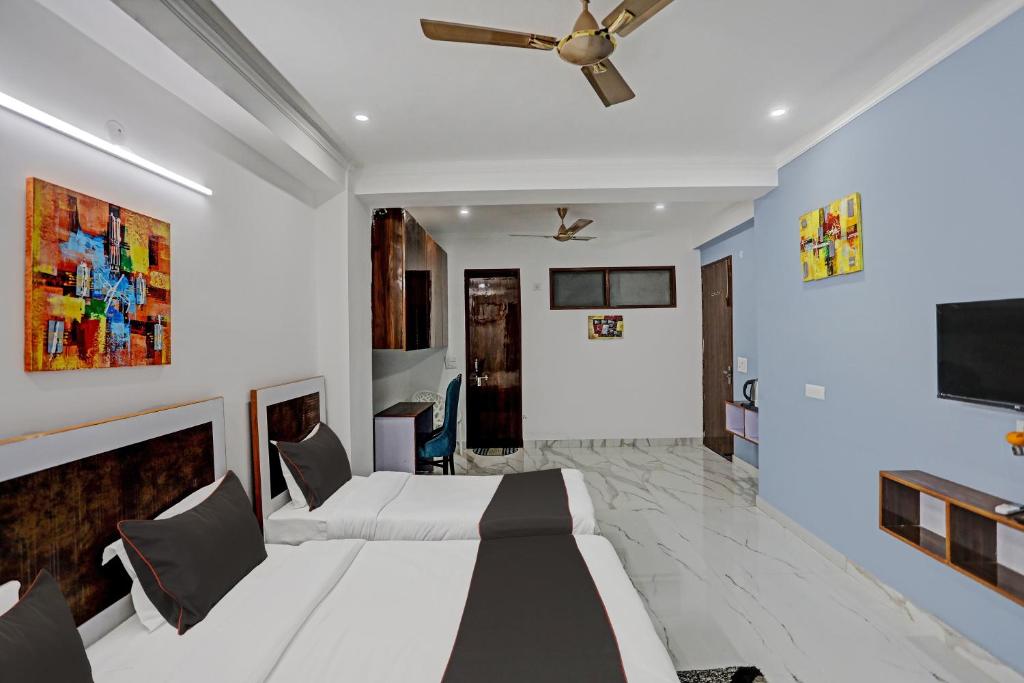 a bedroom with two beds and a ceiling fan at Collection O Kanchan Heritage in Gurgaon