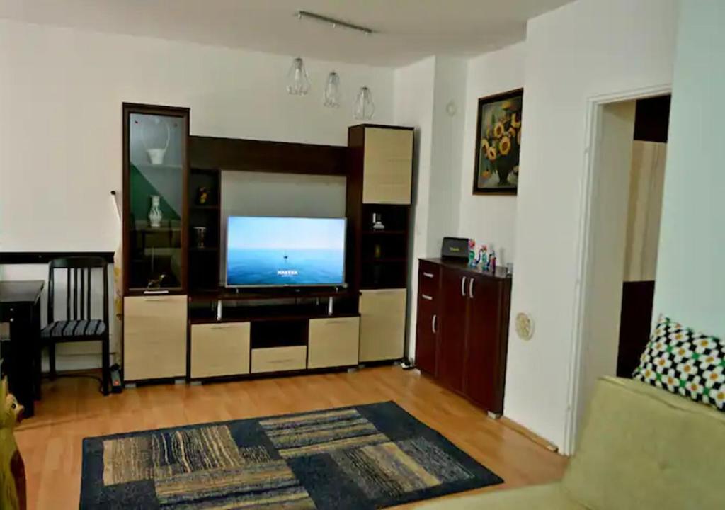 sala de estar con TV de pantalla plana en Three Aces Apartment, en Zemun