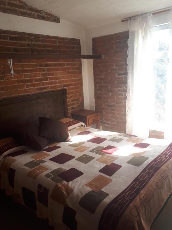 Postel nebo postele na pokoji v ubytování La Misión Cabañas Chignahuapan