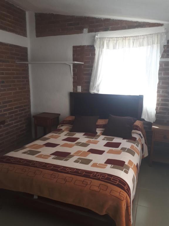 Postel nebo postele na pokoji v ubytování La Misión Cabañas Chignahuapan