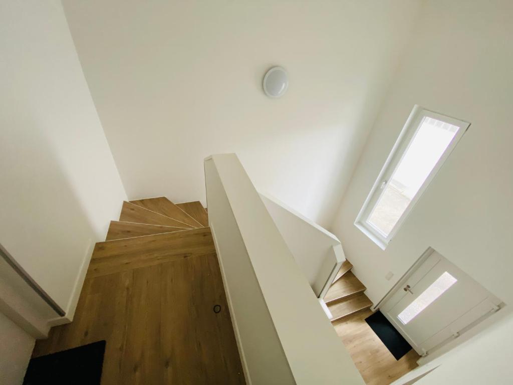 a staircase in a house with a window at Modern One Bedroom + Bathroom Apartment, 10 min from Basel City in Grenzach-Wyhlen