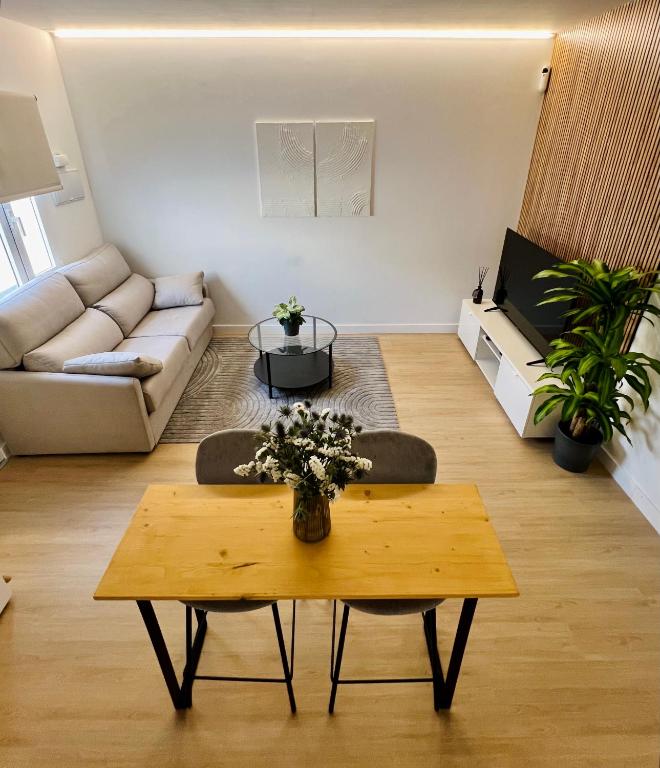 a living room with a couch and a coffee table at Casa céntrica a estrenar in Adeje