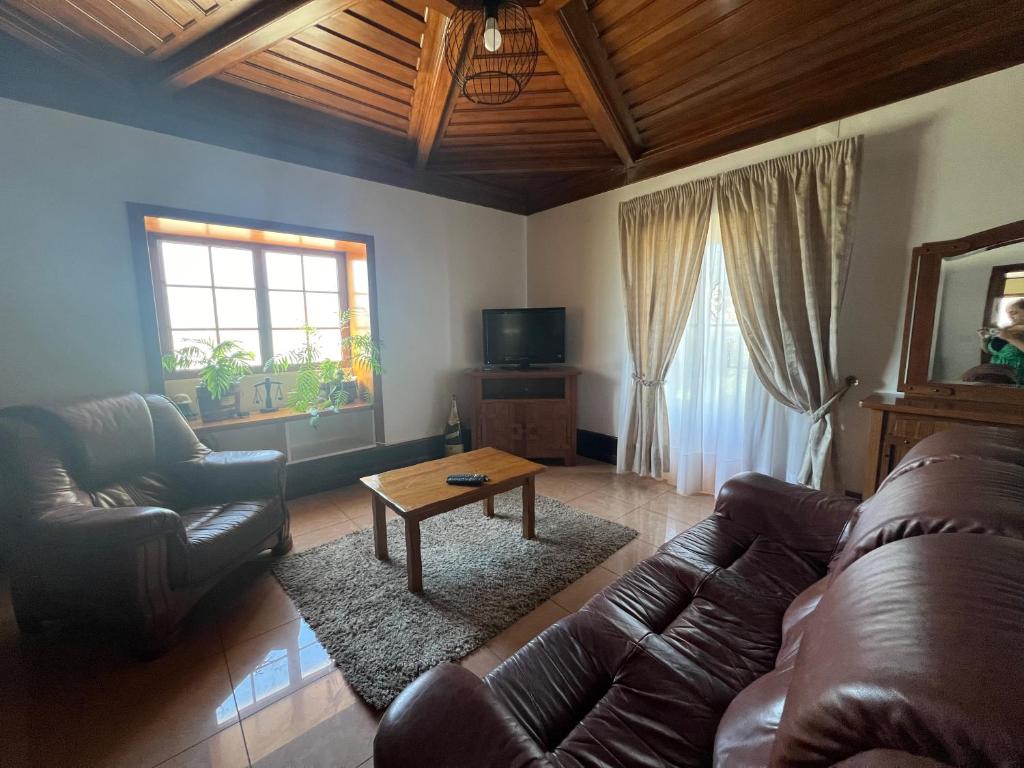 a living room with a couch and a coffee table at Casa do Xisto in Ponte de Lima