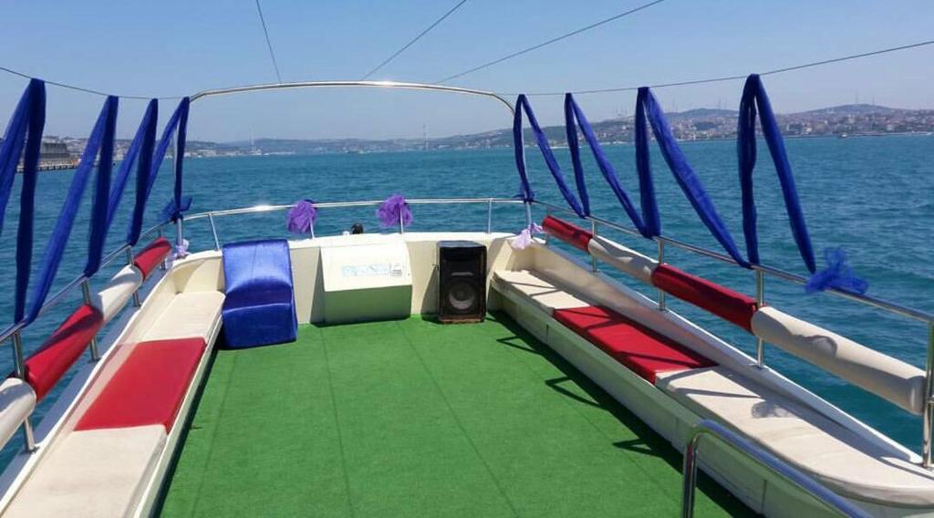 a boat with a green floor and blue flags on it at Kmtyachtstanbul in Istanbul