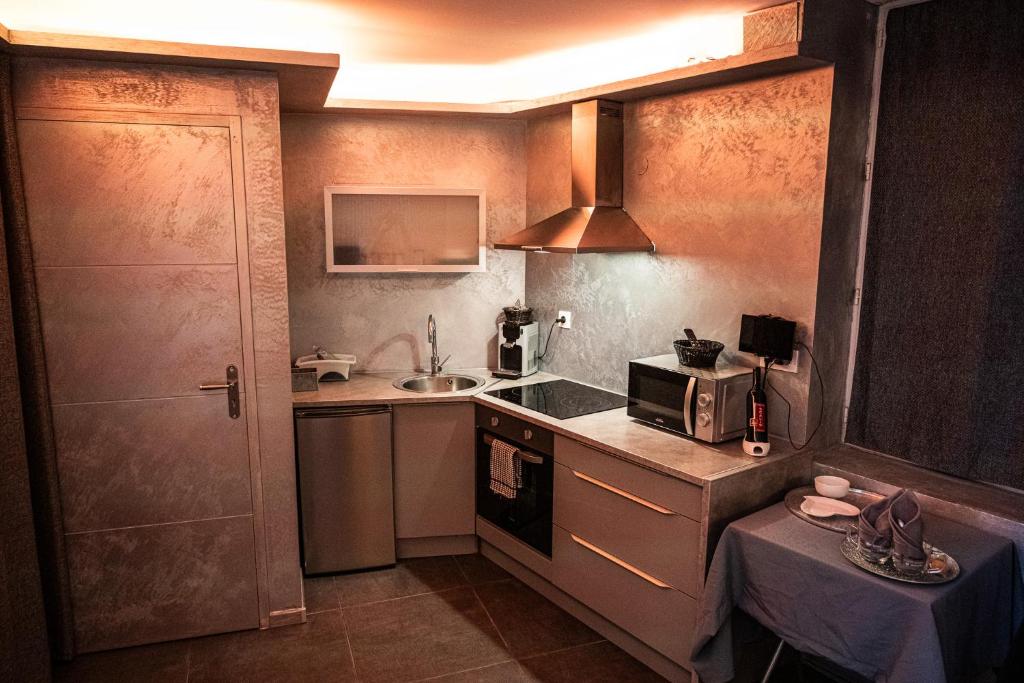 a small kitchen with a sink and a microwave at Suite Romantique in Narbonne